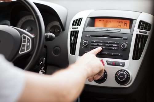 driver turning on the radio