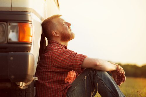 trucker sitting down by truck